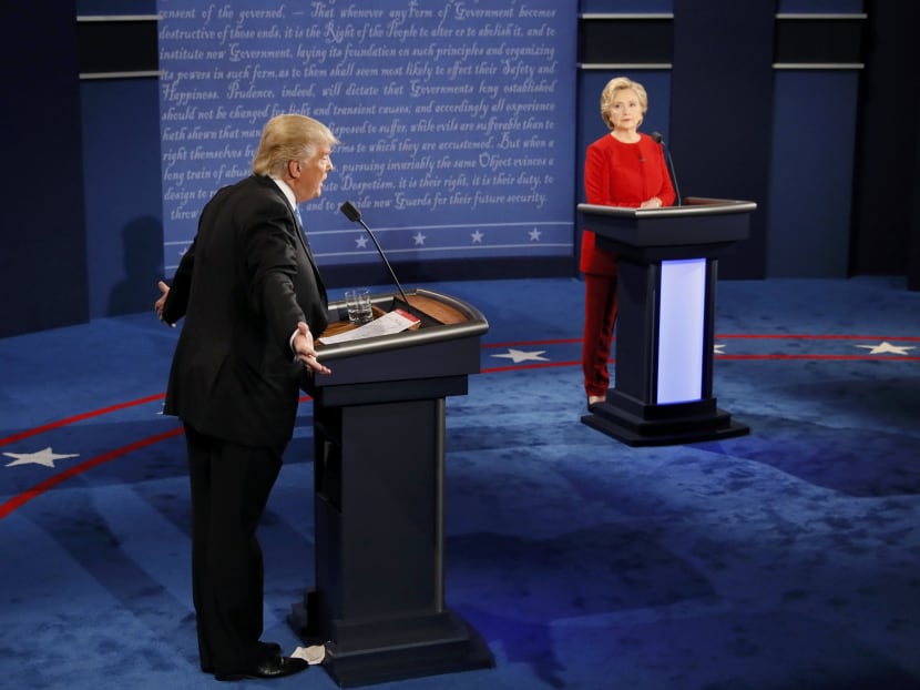 Republican US presidential nominee Donald Trump speaks as Democratic US presidential nominee Hillary Clinton listens during their first presidential debate at Hofstra University in Hempstead, New York. Photo: Reuters
