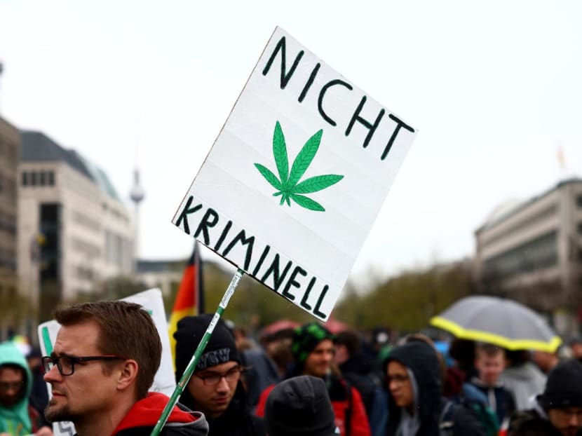 A man carries a sign reading "Not criminal" as he participates in a gathering with marijuana activists to mark the annual world cannabis day and to protest for legalisation of marijuana, in front of the Brandenburg Gate, in Berlin, Germany on April 20, 2022. 
