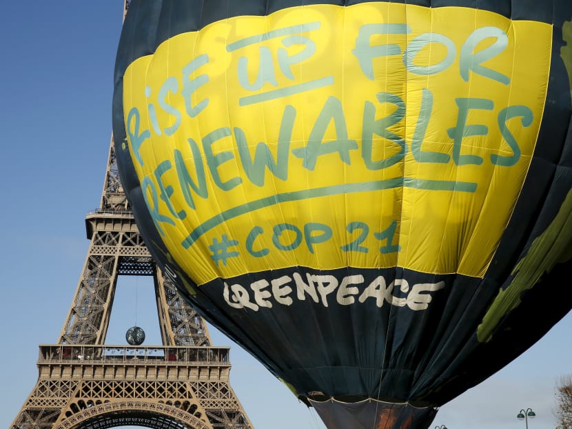 Greenpeace activists fly a hot air balloon depicting the globe next to the Eiffel Tower ahead of the 2015 Paris Climate Conference, known as the COP21 summit, in Paris, France, on Nov 28, 2015. Photos: Reuters