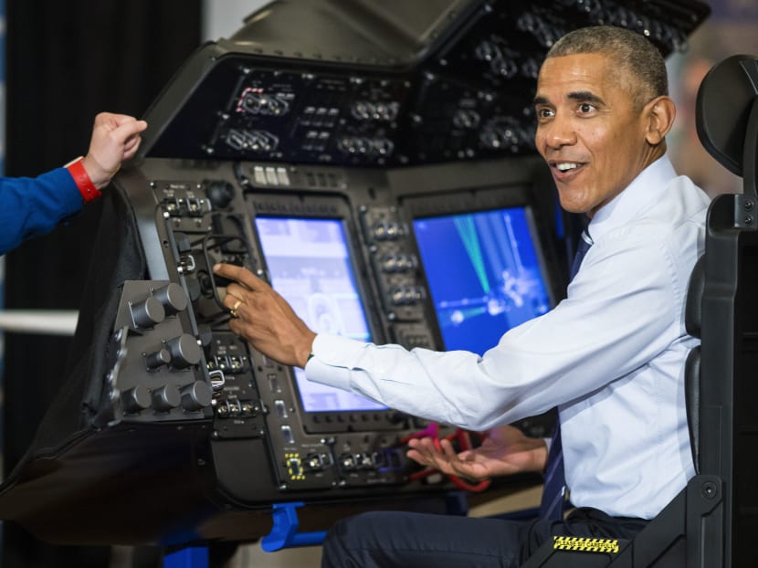 President Barack Obama tries out a spacecraft flight and docking simulator during the White House Frontiers Conference at Carnegie Mellon University in Pittsburgh on Oct 13. Photo: New York Times