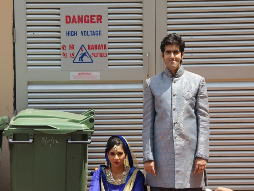 Real-life comedy couple Sharul Channa and Rishi Budhrani have an unusual taste in photo backdrops. Photo courtesy of the artists.