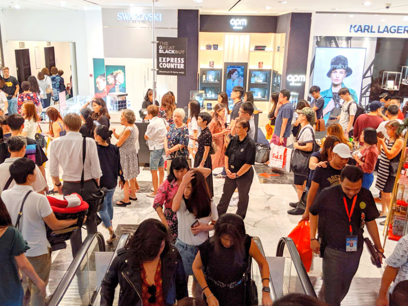 Shoppers queueing up to pay for discounted items at Robinsons department store on Orchard Road on Nov 29, 2019. The store was offering up to 90 per cent discount off products as well as free gifts for those who spend above certain sums.