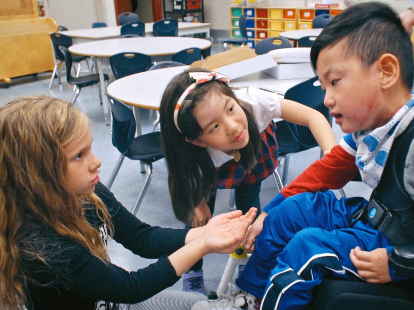 Eight-year-old Joshua (right) with his classmates Mia and Chanelle from Ferris Elementary School. Joshua has Pura syndrome, a neurodevelopmental disorder.
