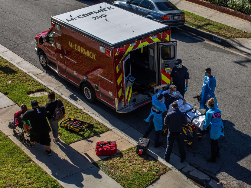 County of Los Angeles paramedics load a potential Covid-19 patient in the ambulance before transporting him to a hospital in Hawthorne, southwestern Los Angeles County, California on Dec 29, 2020.