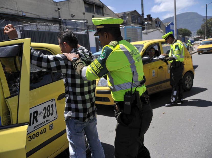 A police officer frisks a taxi driver at a checkpoint in Bogota, Colombia. Bogota has the most dangerous transport system in the world for women travelers, according to a poll conducted by the Thomson Reuters Foundation in 15 major of the world’s largest capitals cities and New York. Photo: Bloomberg