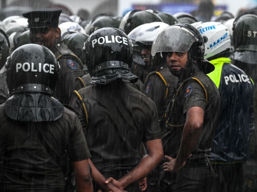 Police stand guard as Sri Lanka's main opposition and Samagi Jana Balawegaya party activists and supporters take part in a protest to urge the government to hold local council elections as scheduled in Colombo on Feb 20, 2023.