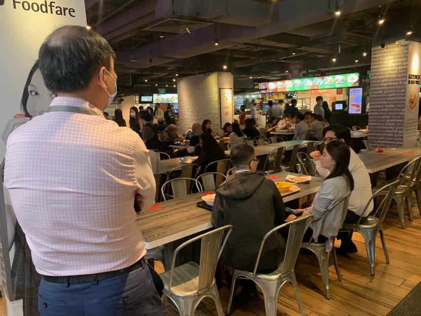 Office workers in the Central Business District waiting for a table at Clifford Centre's food court during their lunch hour.