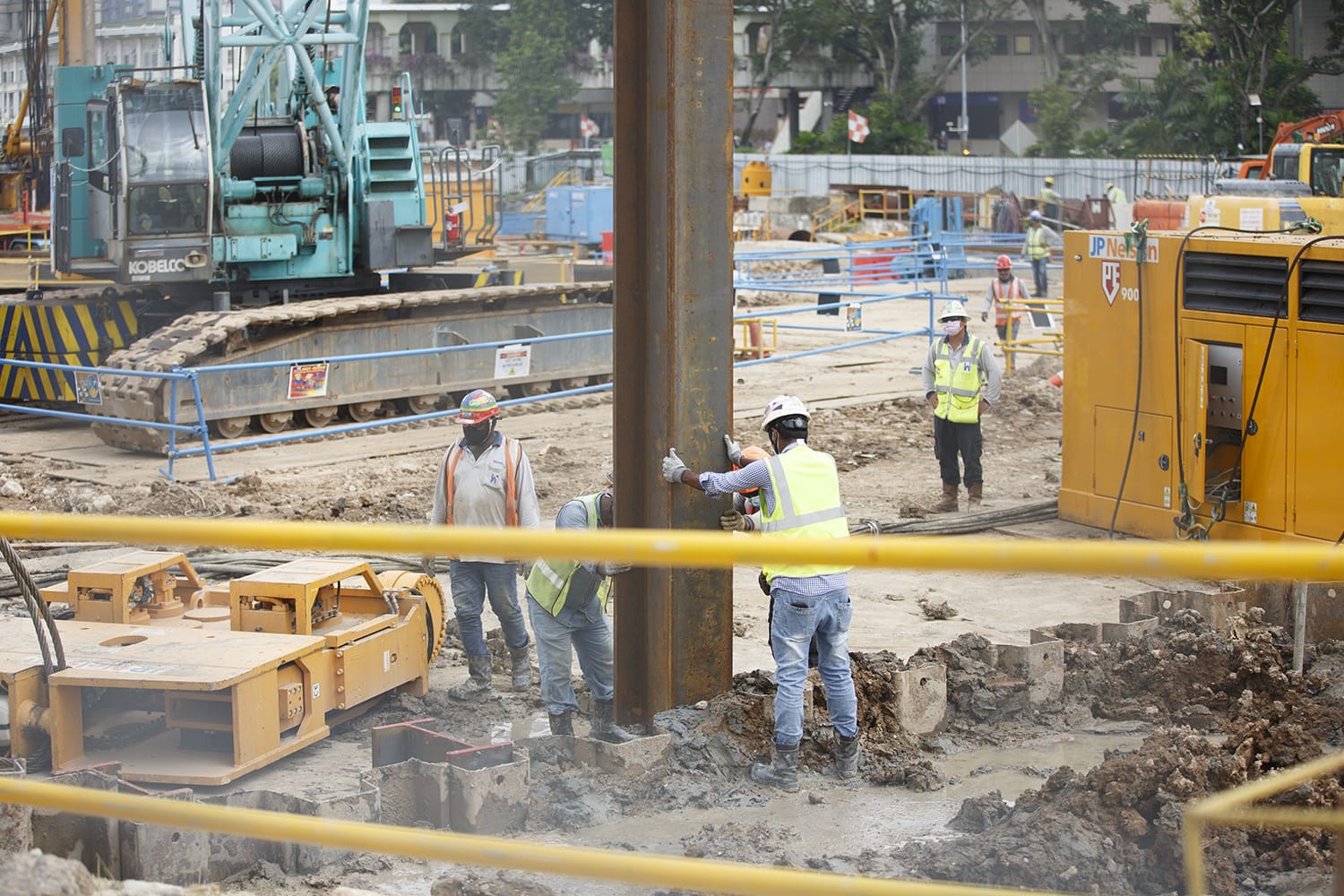 Migrant workers are seen at a construction site along Ophir Road on May 13, 2022. 