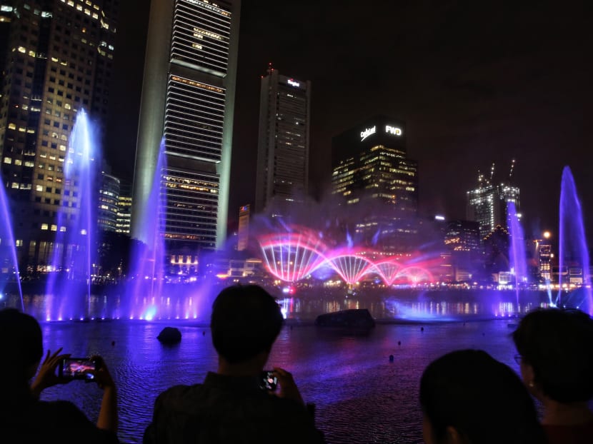 A crowd watching a multimedia show at the Singapore River during the launch of the Singapore Bicentennial on Jan 28.