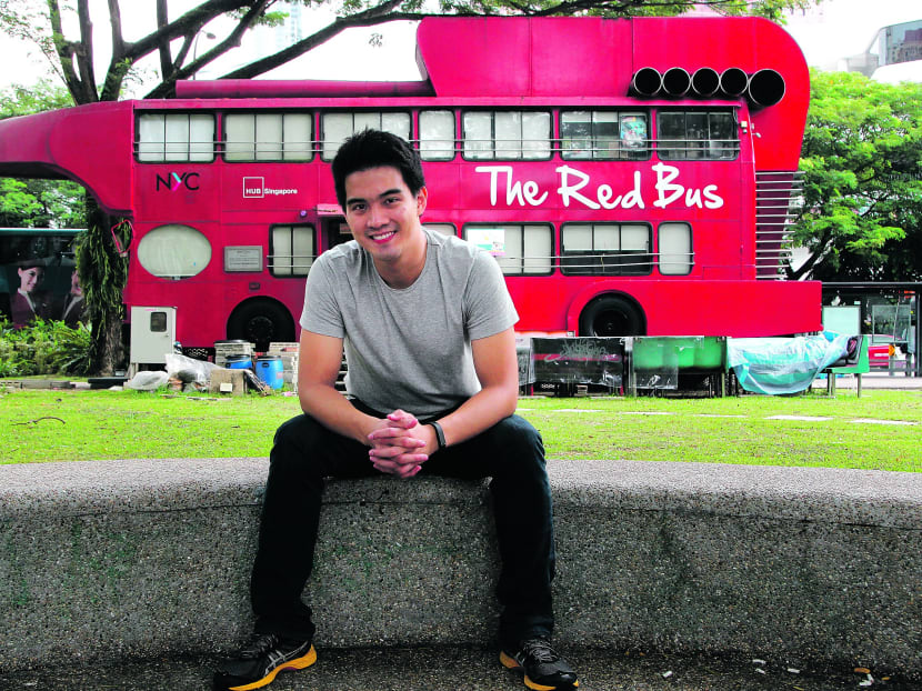 Mr Yi in front of the Big Red Bus outside The HUB Singapore in Somerset. The One Cent Movement is located on the top floor of the bus. Photo: Don Wong