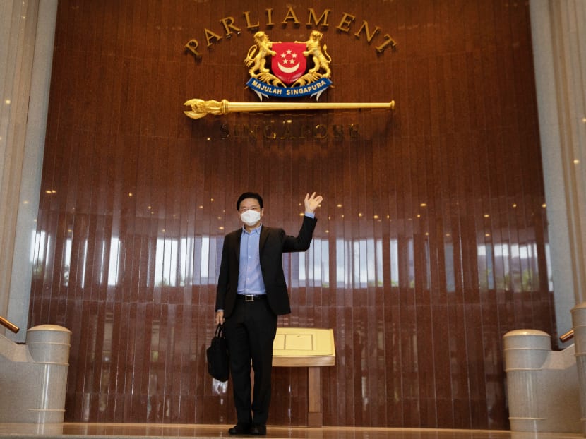 Finance Minister Lawrence Wong arriving in Parliament to deliver the Budget statement on Feb 18, 2022.
