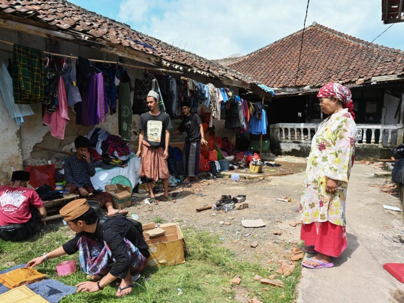 Resident Mimin (right) looks on as others clear salvaged items retrieved from the rubble of homes in Cugenang, Cianjur on November 23, 2022, following a 5.6-magnitude earthquake that hit the area two days ago. Resident Mimin (right) looks on as others clear salvaged items retrieved from the rubble of homes in Cugenang, Cianjur on November 23, 2022, following a 5.6-magnitude earthquake that hit the area two days ago.