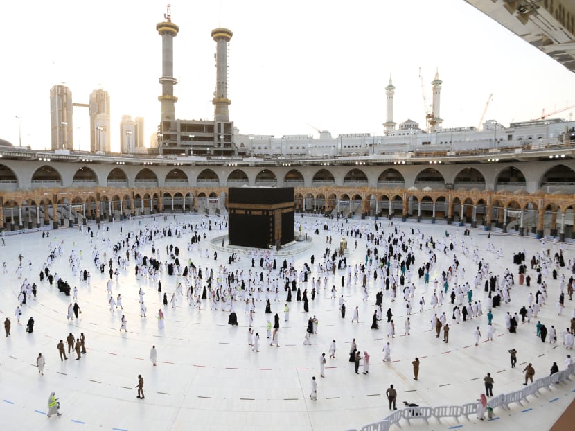 Muslim worshippers gather for prayers around the Kaaba, the holiest shrine in the Grand mosque complex in the Saudi city of Mecca during the first day of the Muslim holy fasting month of Ramadan on April 13, 2021.