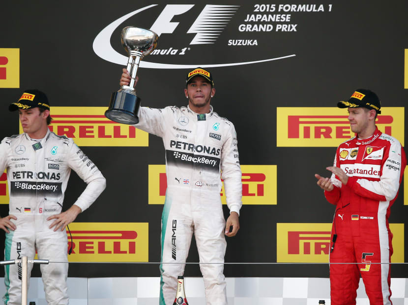 Mercedes driver Lewis Hamilton, centre, of Britain celebrates on the podium after winning the Japanese Formula One Grand Prix at the Suzuka Circuit in Suzuka, central Japan, Sunday, Sept. 27, 2015. Photo: AP
