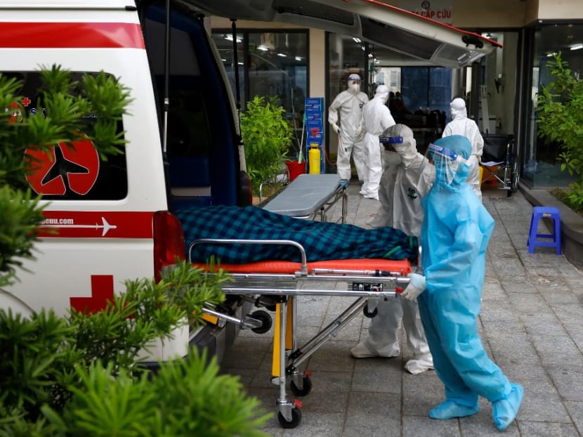This photograph taken on Aug 8, 2021 shows Vietnamese medical workers wearing personal protective equipment as they transfer a Covid-19 coronavirus patient into an ambulance at the Field Hospital Number 6 in Ho Chi Minh City, as Vietnam faces a brutal fourth wave of the virus. This photograph taken on Aug 8, 2021 shows Vietnamese medical workers wearing personal protective equipment as they transfer a Covid-19 coronavirus patient into an ambulance at the Field Hospital Number 6 in Ho Chi Minh City, as Vietnam faces a brutal fourth wave of the virus.