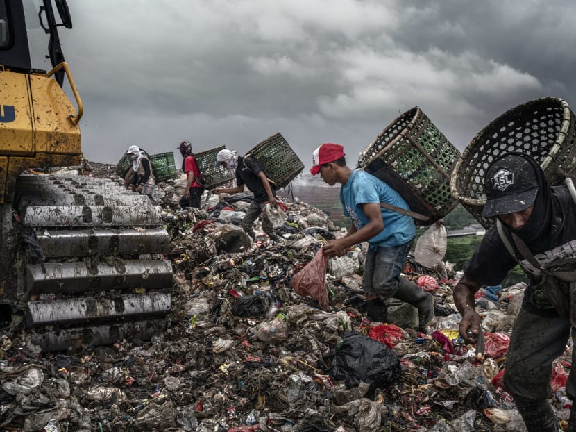 Trash pickers search for recyclable items on Feb 29, 2020, at the Bantar Gabang landfill in Bekasi, Indonesia.