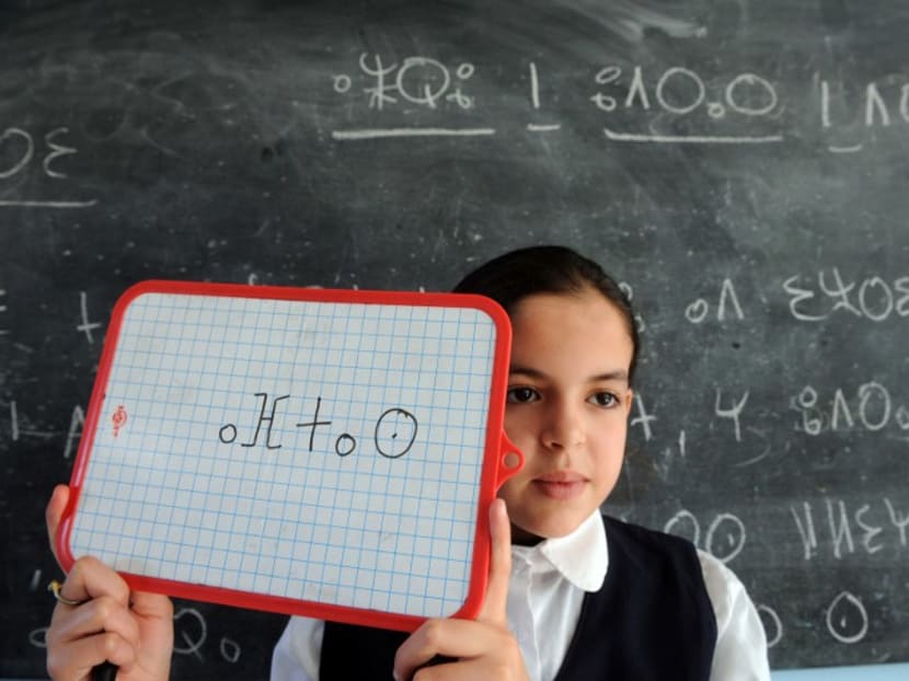 A pupil holds a whiteboard during an Amazigh class, on Sept 27, 2010 in Rabat. AFP file photo