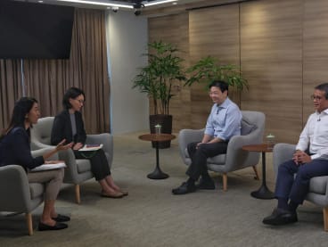 DPM Lawrence Wong (second from right) and Mr Edwin Tong at the interview with CNA.