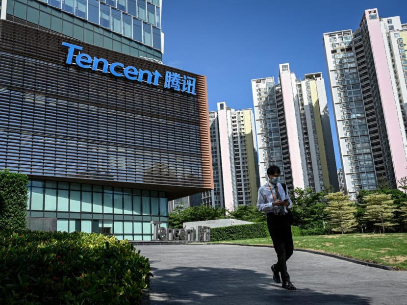 This photo taken on July 10, 2022, shows a man walking past the Tencent headquarters in Shenzhen, in China's southern Guangdong province.

