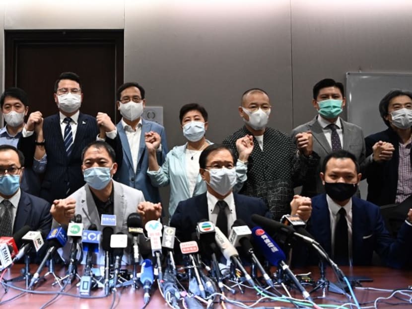 Pro-democracy lawmakers join hands at the start of a press conference in a Legislative Council office in Hong Kong on Nov 11, 2020. Hong Kong's pro-democracy lawmakers said on Nov 11 they would all resign, after China gave the city the power to disqualify politicians deemed a threat to national security and four of their colleagues were ousted.