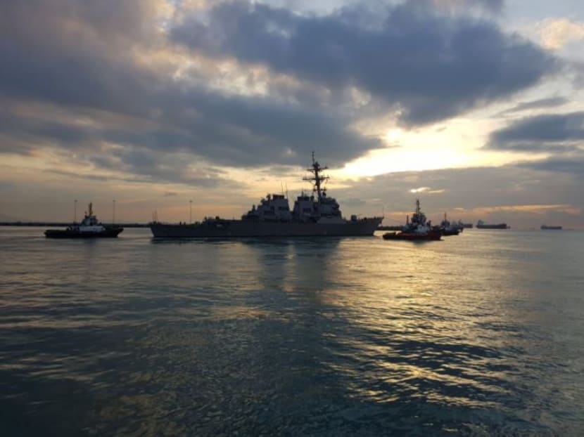 The guided missile destroyer USS John S. McCain is towed away from the pier at Changi Naval Base on Oct 5, to meet heavy lift transport vessel MV Treasure. Photo: US Seventh Fleet