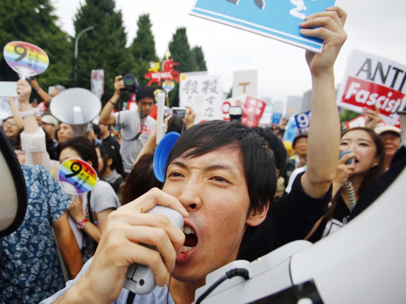 Protesters rallying in front of the National Diet building in Tokyo on Sunday. Grass-roots movements among typically apolitical groups such as mothers and students appear to be growing. PHOTO: AP