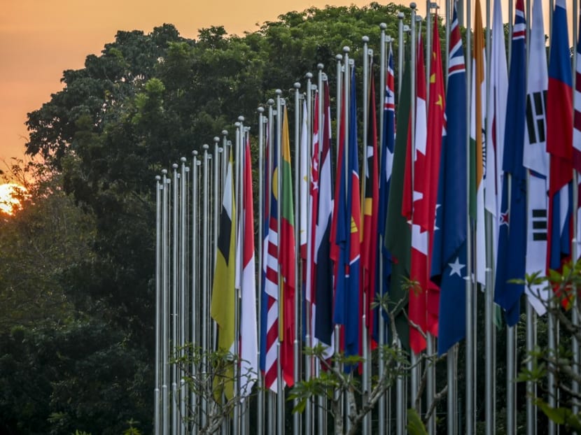 The sun sets behind tree adjacent to participant countries' flags during the 43rd Association of Southeast Asian Nations (ASEAN) Summit in Jakarta on Sept 7, 2023.