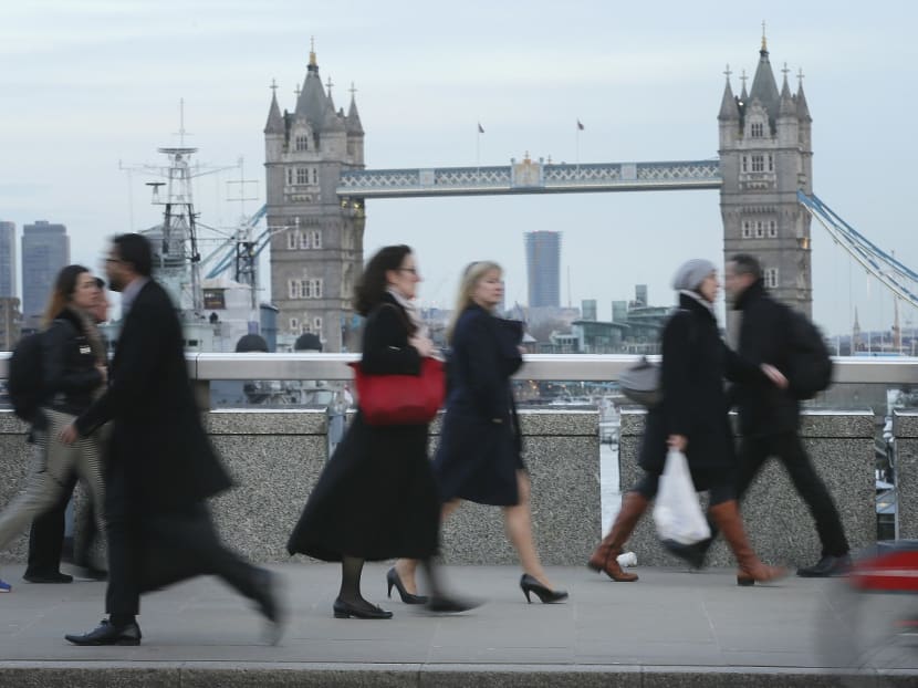 A person walks in high heels on London Bridge as today MPs debate a ban on companies imposing high heels as part of dress codes for female employees, in response to a petition started by a receptionist who was sent home for wearing flat shoes. Photo: AP