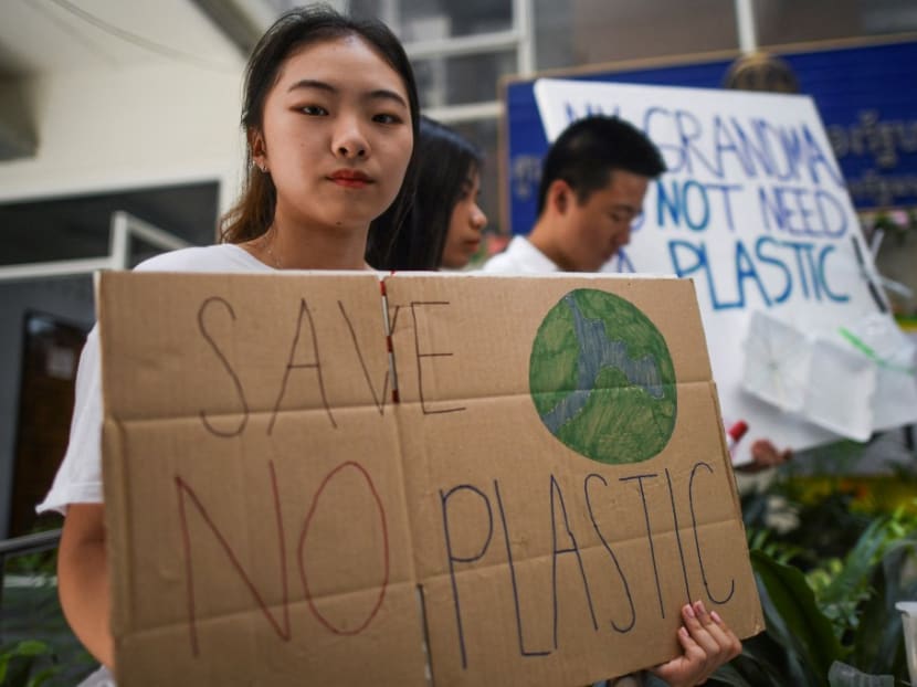 Thai students hold up placards during a climate change demonstration in Bangkok on March 15, 2019, as part of a global movement called #FridaysForFuture.