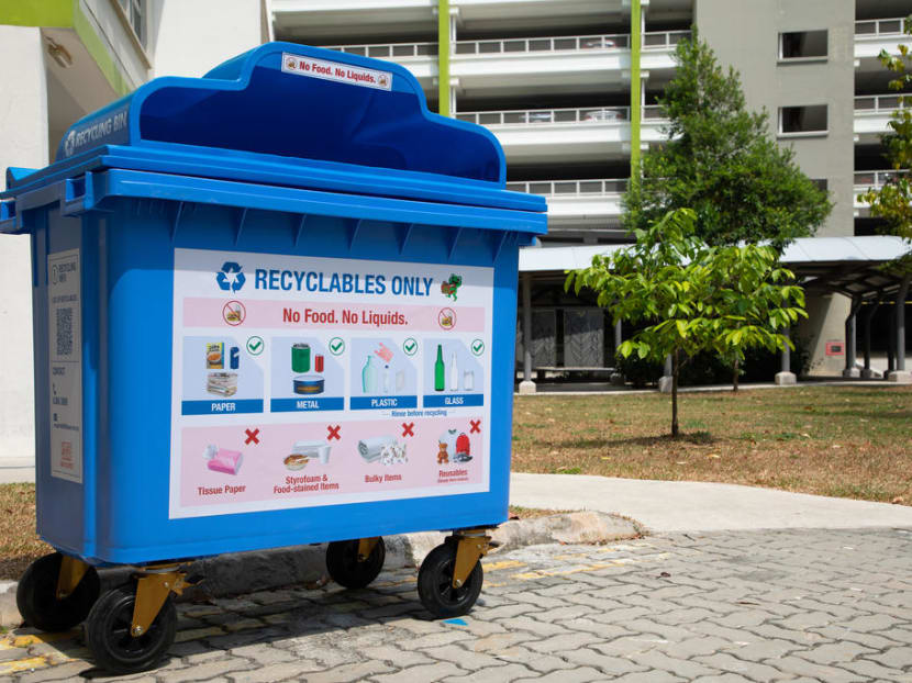 Blue recycling bins with labels that convey more explicitly what can and cannot be placed in the bins.