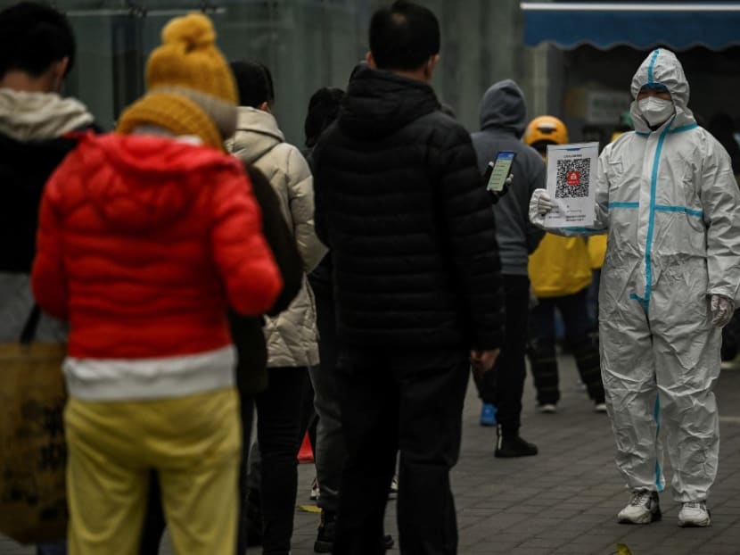 This file photo taken on Nov 20, 2022 shows people queueing to test for the Covid-19 coronavirus at a swab collection station in Beijing.
