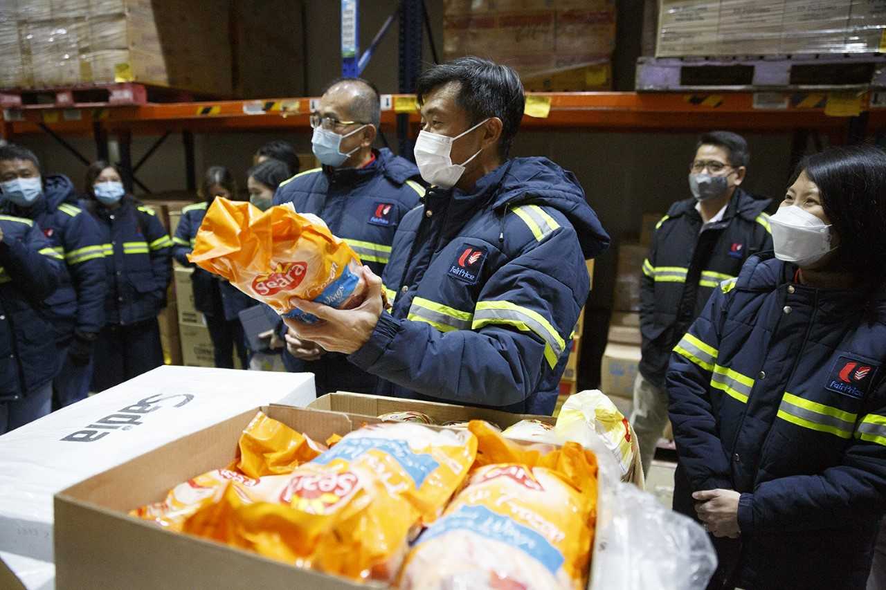 Minister of State for Home Affairs and Sustainability and the Environment Desmond Tan holds at a bag of frozen food during a visit to the NTUC Fresh Food Distribution Centre on May 26, 2022.