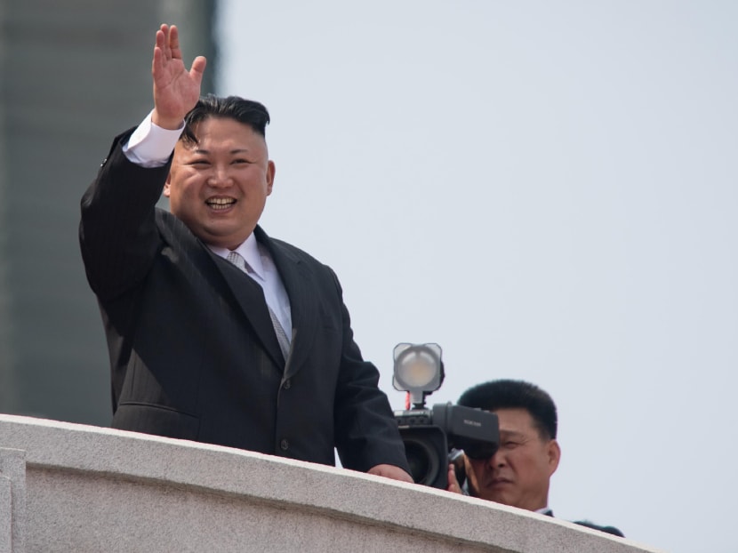 North Korean leader Kim Jong Un waving from a balcony of the Grand People's Study House following a military parade marking the 105th anniversary of the birth of late North Korean leader Kim Il-Sung in Pyongyang on April 15, 2017.