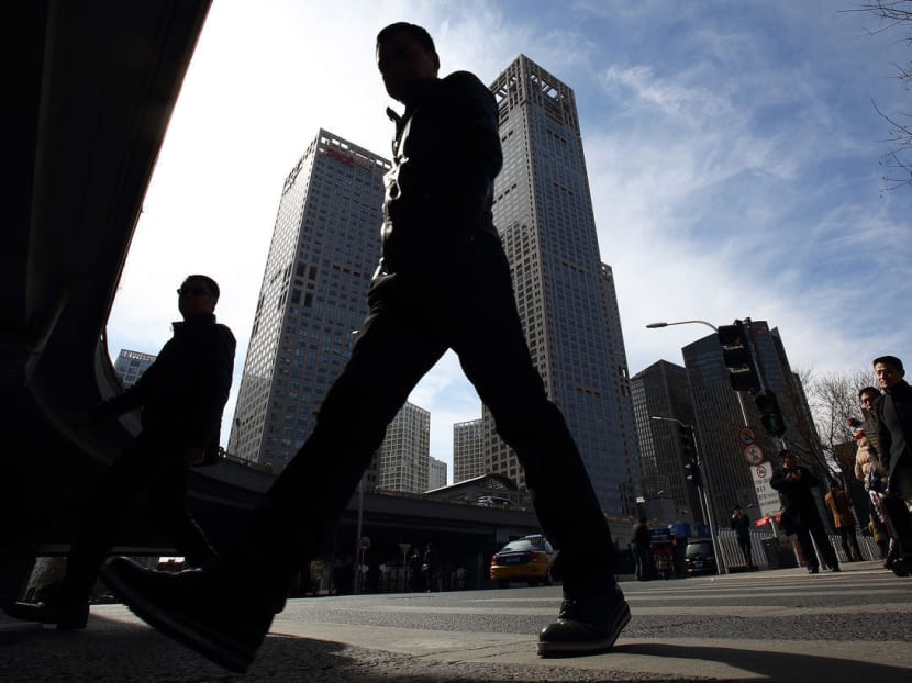 Pedestrians walk in the central business district of Beijing. Photo: Bloomberg