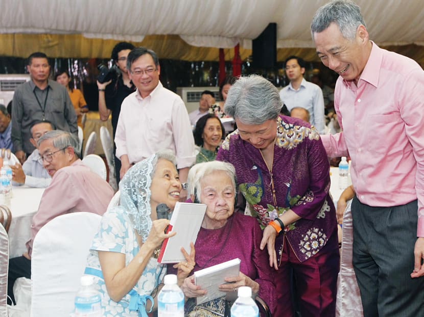 100 receive Pioneer Generation cards from PM Lee at launch