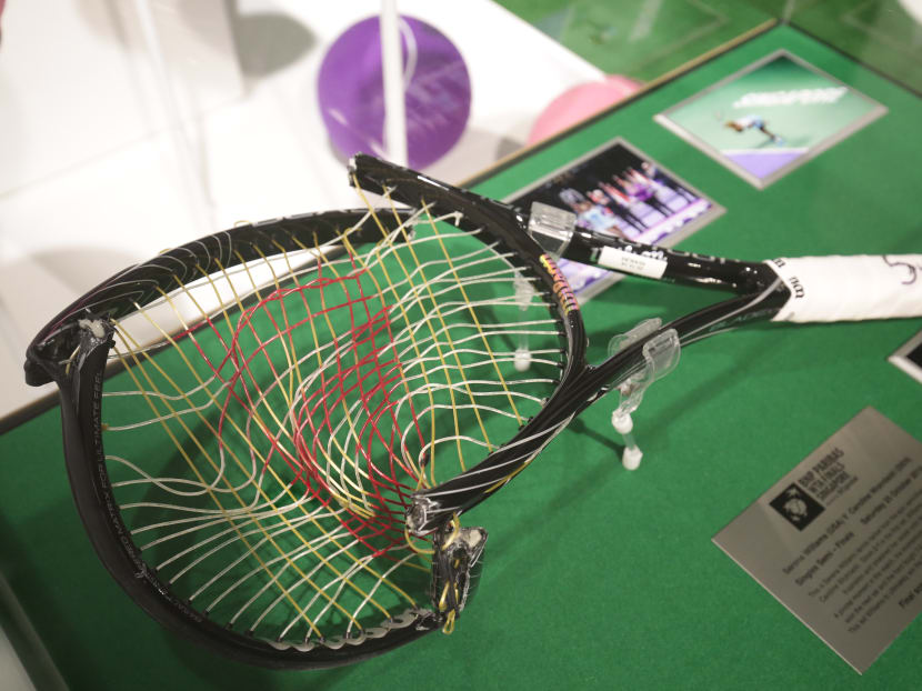 On display at the Graceful Grit exhibition is, among others, the broken and bent racket that was smashed by current world no. 2 Serena Williams during the semi-finals of the 2014 WTA Finals. Photo: Singapore Sports Hub