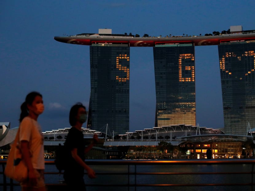 The Marina Bay Sands integrated resort lights up in tribute to the healthcare workers and people staying home to curb the spread of Covid-19 in Singapore, on April 10, 2020.