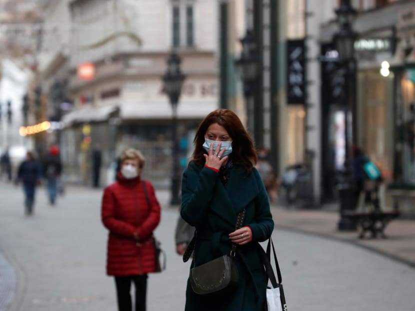 People wearing protective face masks walk in downtown Budapest. Photo: Reuters