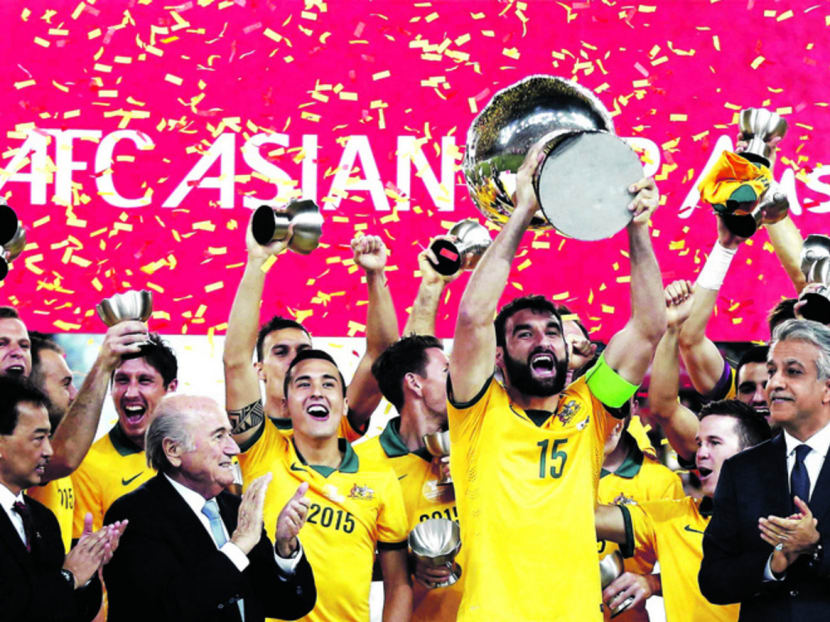Australian captain Mile Jedinak (centre) and his team celebrating their historic Asian Cup win. Photo: Reuters