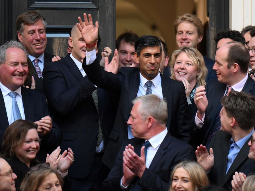 New Conservative Party leader and incoming prime minister Rishi Sunak (centre) waves as he arrives at Conservative Party Headquarters in central London having been announced as the winner of the Conservative Party leadership contest, on Oct 24, 2022