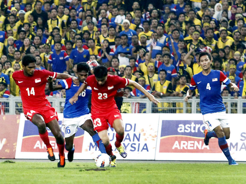 The match between traditional rivals Singapore (in red) and Malaysia has the potential to fill the new National Stadium ... if they can agree on a date. TODAY FILE PHOTO