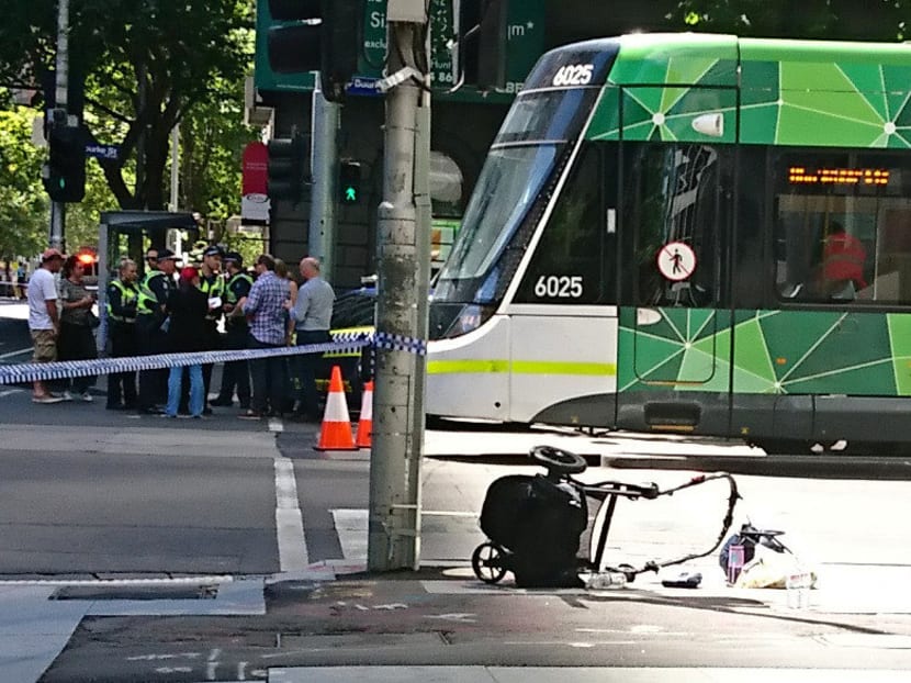 The wreckage of a pram is seen on the footpath in front of a tram on a main street after a car hit pedestrians in central Melbourne, Australia, Jan 20, 2017. Photo: AAP via Reuters