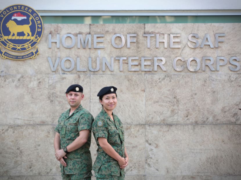 Newly promoted SAFVC SV2 Nicolas Michel Mas with his wife Ting Hui Shan, also an SAFVC member, before the passing out and promotion parade on Saturday. They both serve as auxiliary security troopers by guarding key installations during events. Photo: Jason Quah