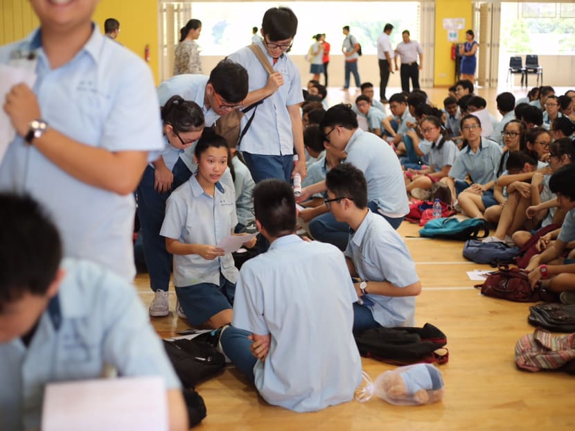 Students collecting their GCE O-Level examination results at Yuan Ching Secondary School. Under the new subject-based banding system, there will be a new secondary school curriculum and each subject will be categorised into three tiers: General 1 (G1), General 2 (G2), and General 3 (G3).