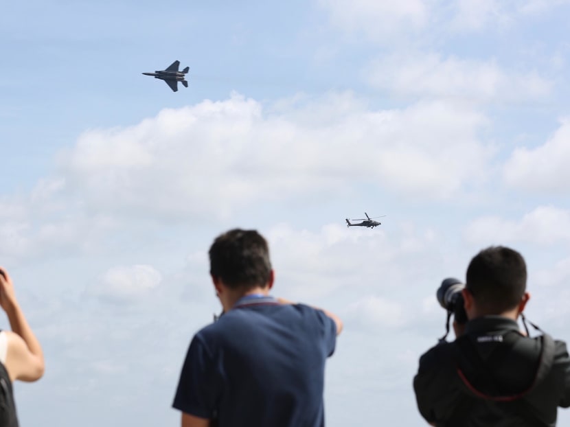 The RSAF’s F-15SG and Apache AH-64D helicopter performing a series of manoeuvres at the Singapore Airshow 2020. Photo: Najeer Yusof/TODAY