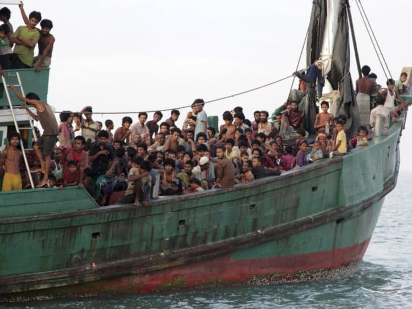 Rohingya and Bangleshi migrants wait on board a fishing boat before being transported to shore, off the coast of Julok, in Aceh province, May 20, 2015. Photo: Reuters