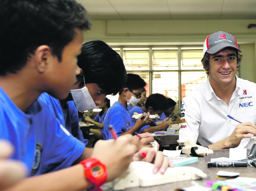 Gutierrez building a balsa wood model car at the Sauber F1 team and Chelsea Football Club’s cross-sport activity at Henderson Secondary School yesterday. Photo: Getty Images
