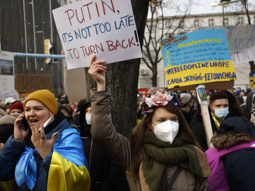Protestors holding placards stand in front of the Russian embassy in Berlin to demonstrate for peace in Ukraine on Feb 27, 2022. 