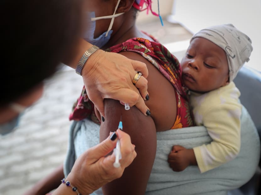 A healthcare worker administers a Covid-19 vaccine to a woman, amidst spread of the Sars-CoV-2 variant Omicron in Johannesburg, South Africa on Dec 04, 2021.