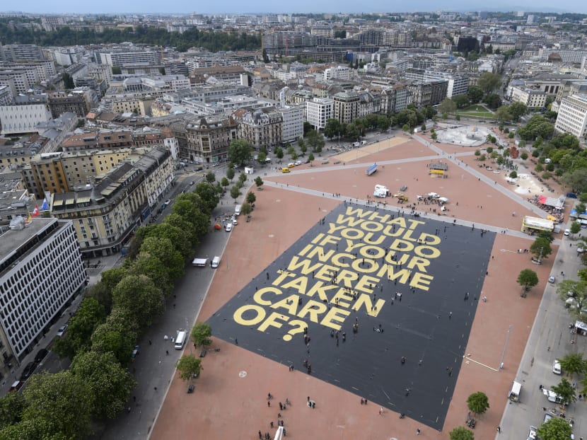 This photo taken on May 14, 2016 in Plainpalais place in Geneva shows a giant poster reading "What would you do if your income was taken care of?", setting the Guinness World Record for the largest poster ever printed. Photo: AFP